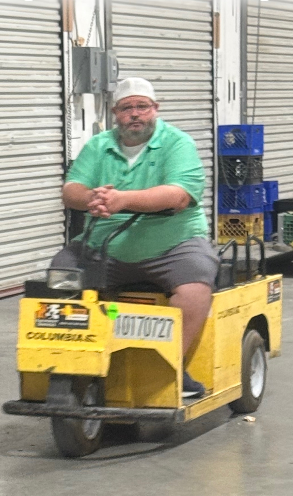 Example upload: a warehouse worker sitting on a yellow cart